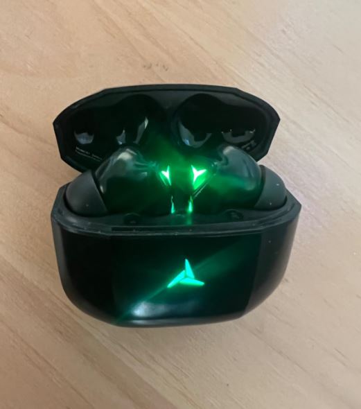 The Tozo G1 earbuds logo glowing, real product test image 